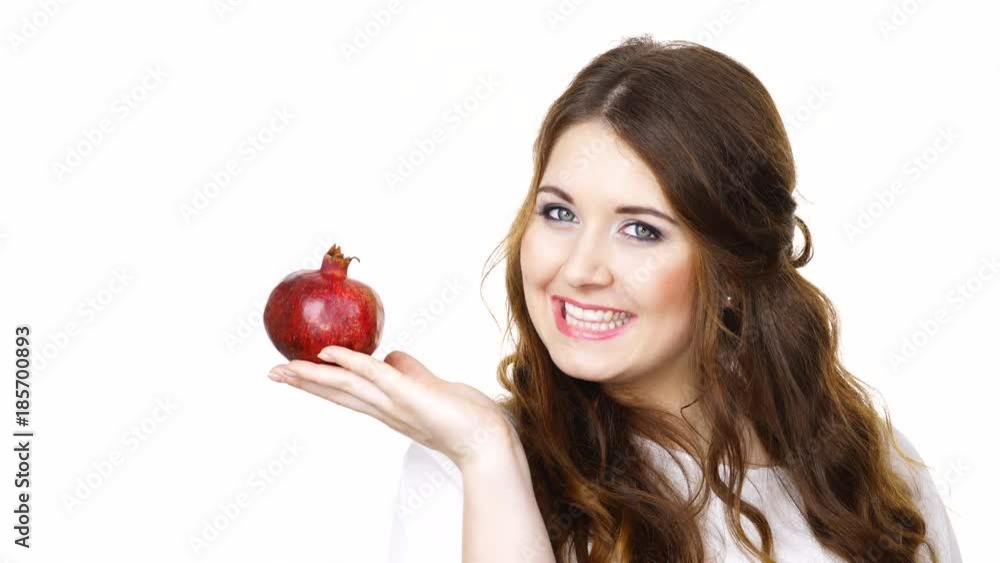 Woman cheerful girl holding pomegranate fruit in hand, making thumb up sign gesture, isolated on white. Healthy eating, cancer prevention, immune support. Woman cheerful girl holding pomegranate fruit in hand, making thumb up sign gesture, isolated on white. Healthy eating, cancer prevention, immune support.