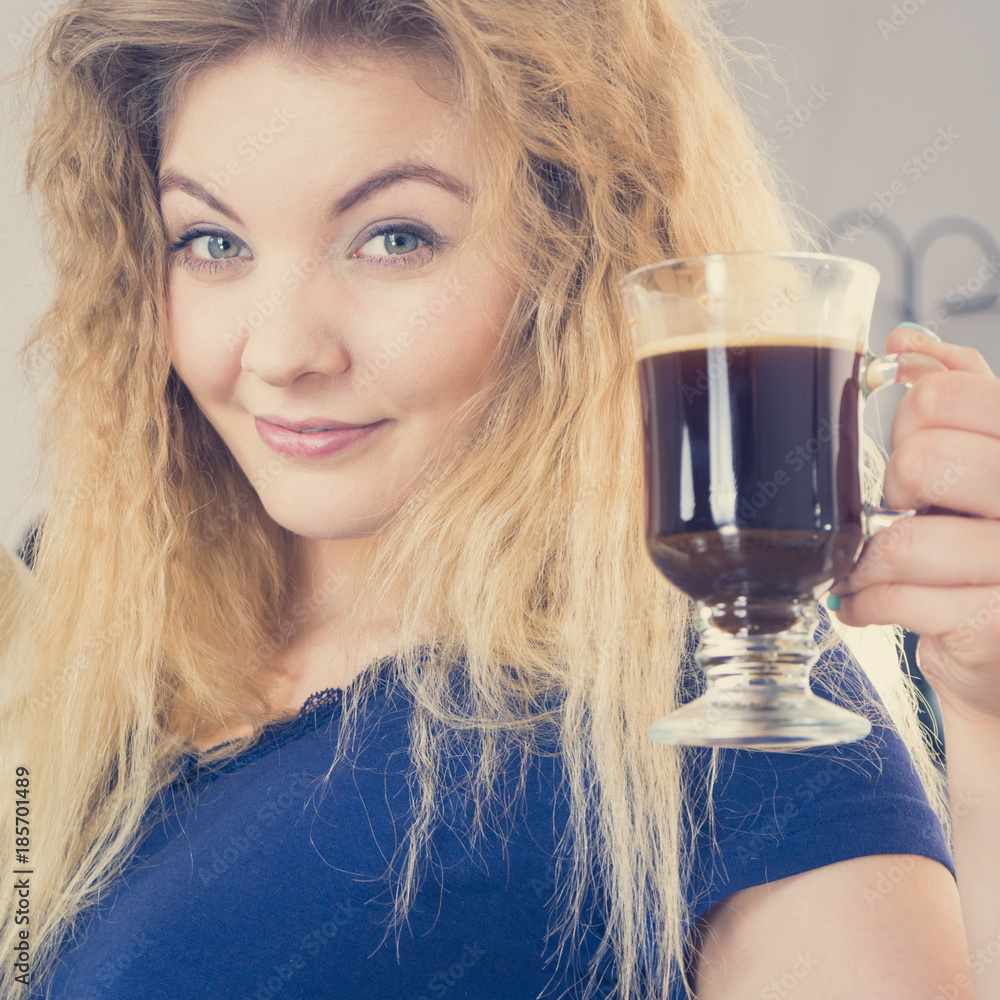 Positive woman drinking her morning coffee Positive woman drinking her morning coffee