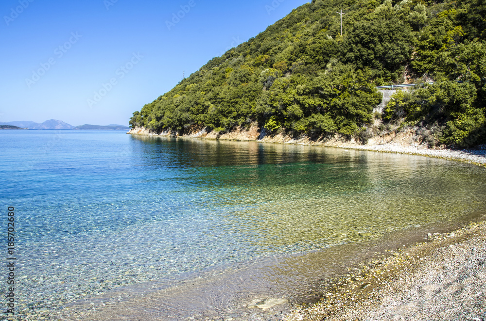 calm and clear waters on the beach of Krovoulia Ithaka