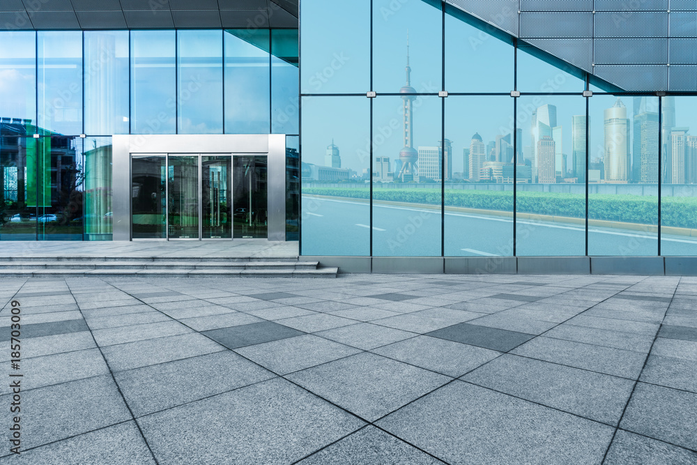 buildings and clean road reflected on the glass wall. buildings and clean road reflected on the glass wall.