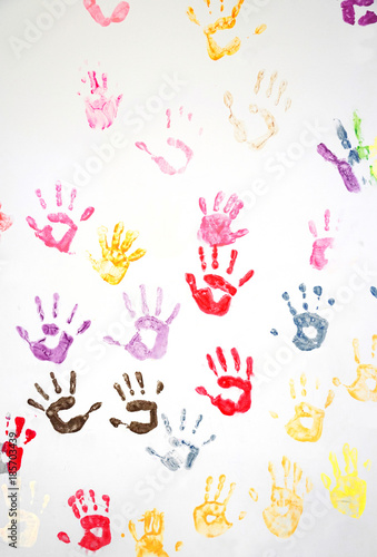 Colorful hand prints on the white wall