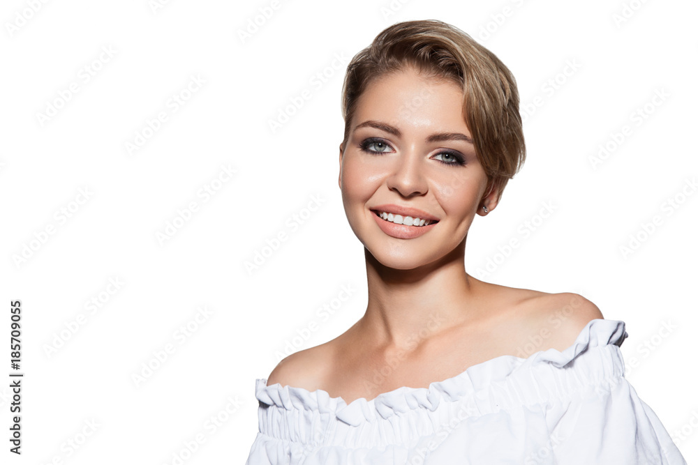 Young beautiful woman with stylish short haircut, studio portrait. Attractive model smiling and looks at camera. Portrait of cute girl with fresh make-up, isolated on white background. Young beautiful woman with stylish short haircut, studio portrait. Attractive model smiling and looks at camera. Portrait of cute girl with fresh make-up, isolated on white background.