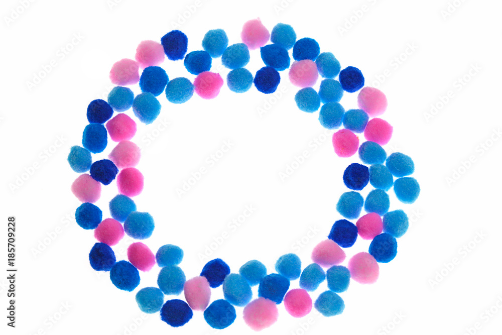 Pompon background. round frame of pink, light blue and blue small pompons isolated on white background. Needlework, hobby, creativity with children concept