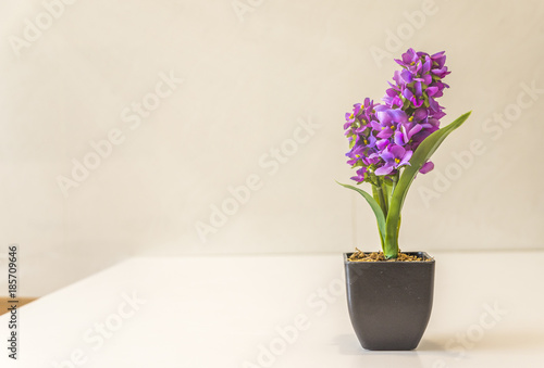 Artificial Flowers on white table with space for copy