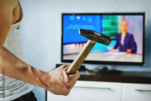 Tableau sur toile Exasperated the young man the bad news breaks the TV