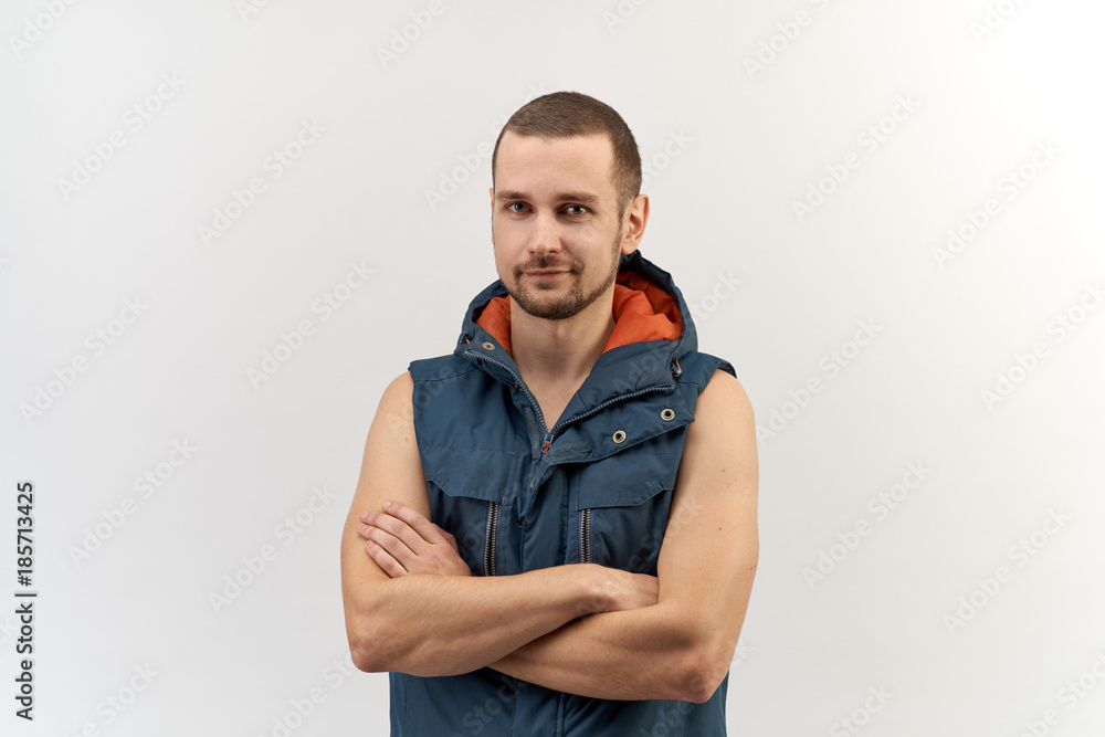 young attractive confident man posing for a portrait with folded arms, dressed in sporty all-season tunic top in a happy smiling expression young attractive confident man posing for a portrait with folded arms, dressed in sporty all-season tunic top in a happy smiling expression
