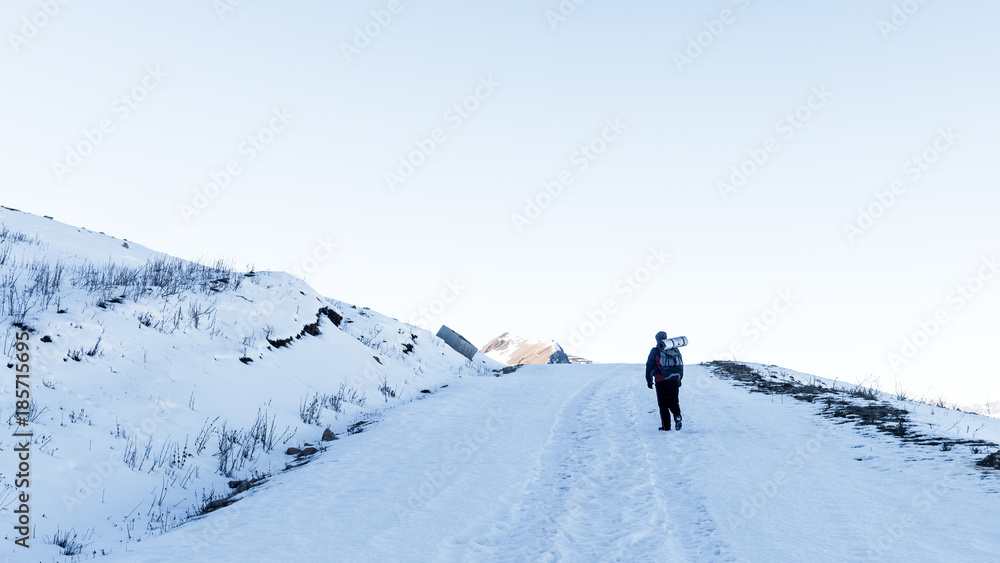 Tourist climber on a mountain snow trail