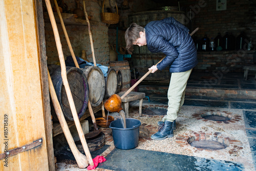 Girl is cleaning of the georgian wine kvevri photo