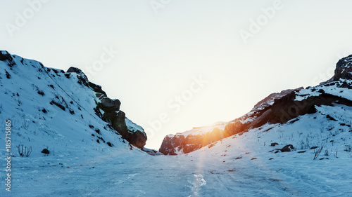 Last rays of sun on a snowly mountain peak
