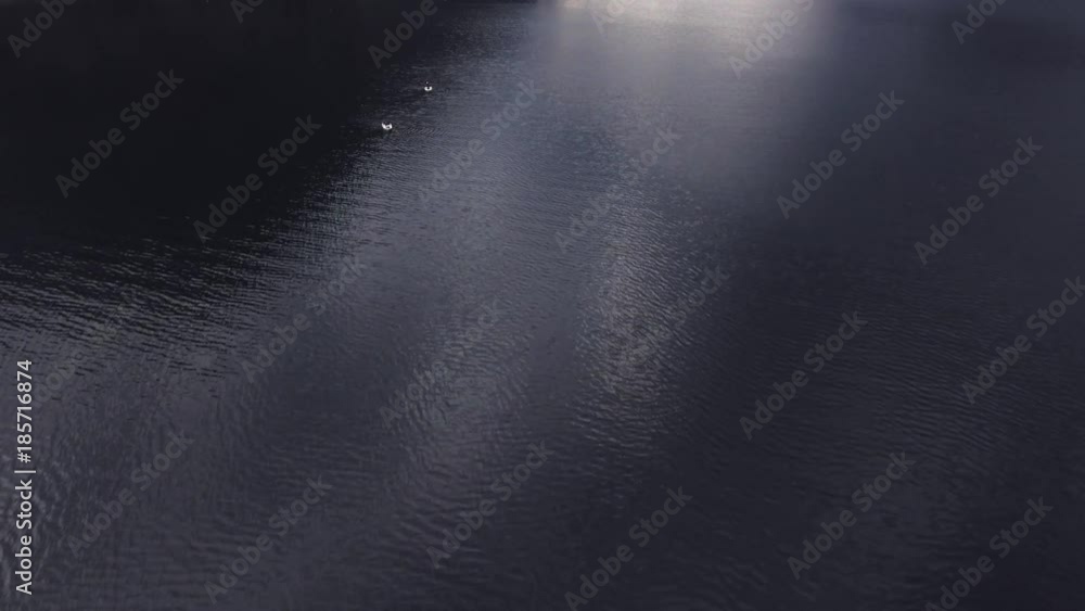Shooting from helicopter flying over a pond, sea, ocean. Fishermen are sitting in fishing boats in the middle of the sea in Norway, Europe. Smooth surface of the sea with a ripple on the water Shooting from helicopter flying over a pond, sea, ocean. Fishermen are sitting in fishing boats in the middle of the sea in Norway, Europe. Smooth surface of the sea with a ripple on the water