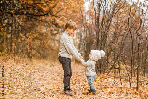 children walk in the autumn park © Ermolaev Alexandr