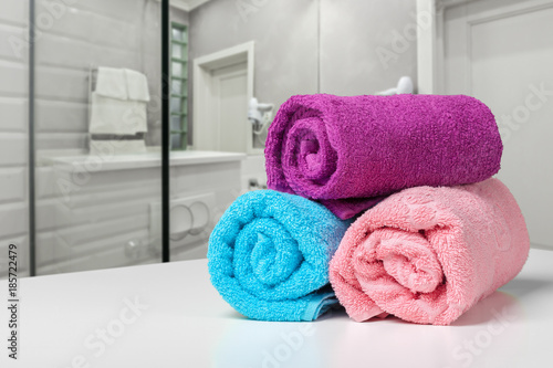 Bright colored towel on a shelf in a bathroom