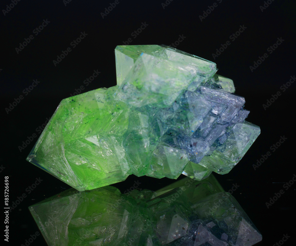 Green natural crystal mineral on a black background Green natural crystal mineral on a black background