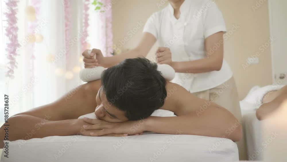 Young couple lying down on massage beds at Asian luxury spa. Relaxing and health Young couple lying down on massage beds at Asian luxury spa. Relaxing and health