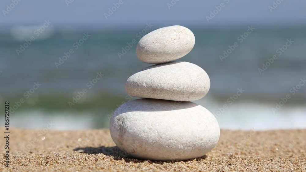Balanced Spa Stones on a sandy beach against background of the Sea Balanced Spa Stones on a sandy beach against background of the Sea