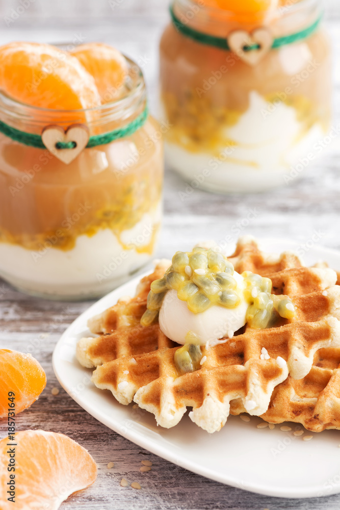 Wafers with mascarpone cheese and passion fruit. Yogurt in small jars with tangerine. Wafers with mascarpone cheese and passion fruit. Yogurt in small jars with tangerine.