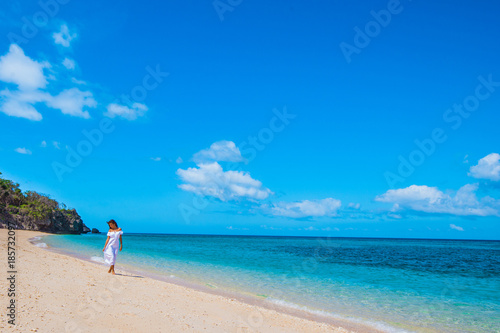 Woman in a white dress on beach