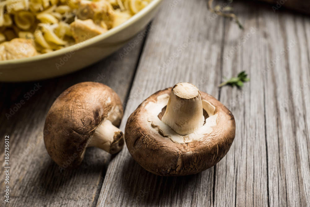 Fresh mushrooms on the rustic wooden background. Selective focus. Shallow depth of field. Fresh mushrooms on the rustic wooden background. Selective focus. Shallow depth of field.