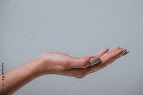 Woman's hand on grey background