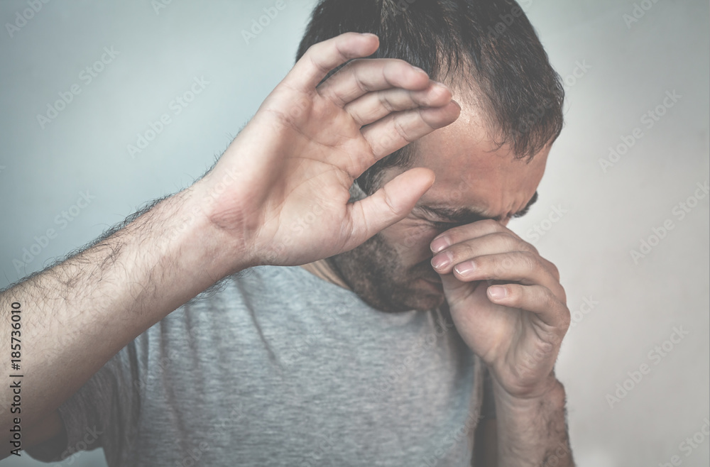 Fototapeta premium Sad caucasian man crying.