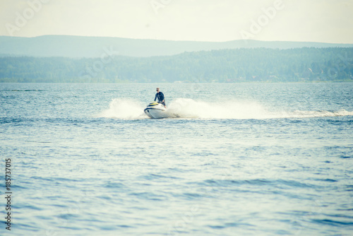 Dona Paula, Goa, India - February 15, 2017: Tourist enjoy water scooter ride in the sea around Dona Paula in Goa, India. photo