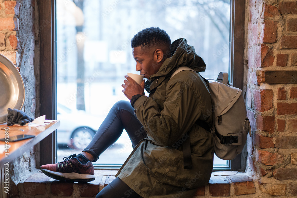 Tourist having warm coffee in cafe Tourist having warm coffee in cafe