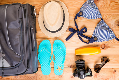 suitcase and ready objects for a woman to relax on the beach