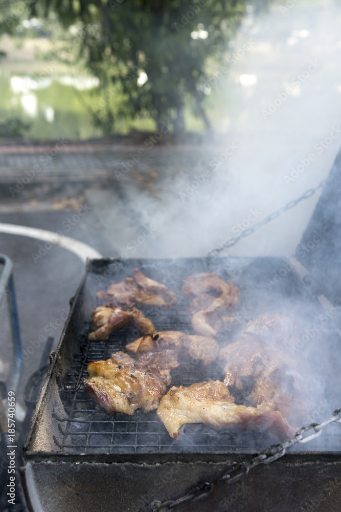 Thai style grilled pork Grill with smoke, street truck food shop, in Bangkok, Thailand Thai style grilled pork Grill with smoke, street truck food shop, in Bangkok, Thailand