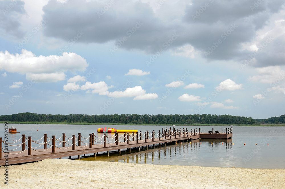 river and pier at recreation center on cloudy summer day