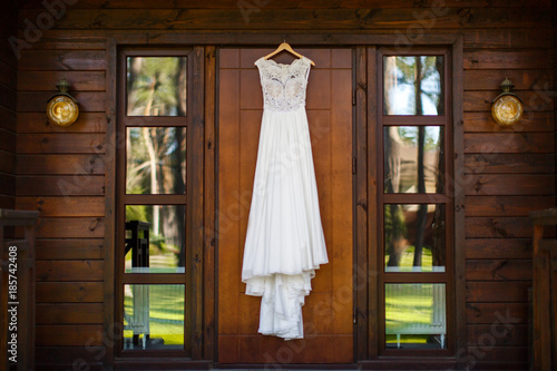 Wedding dress hanging on the wooden door