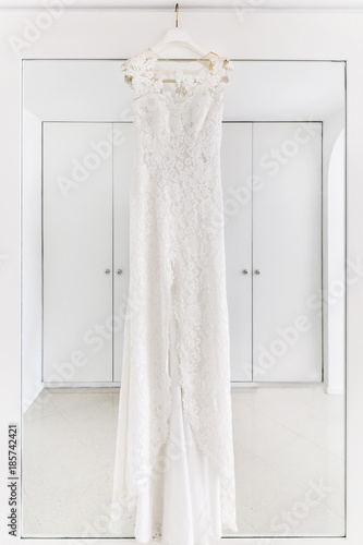 Wedding dress hanging in the white room