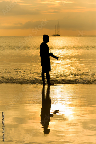 silhouette of photographer at the beach © khobenz