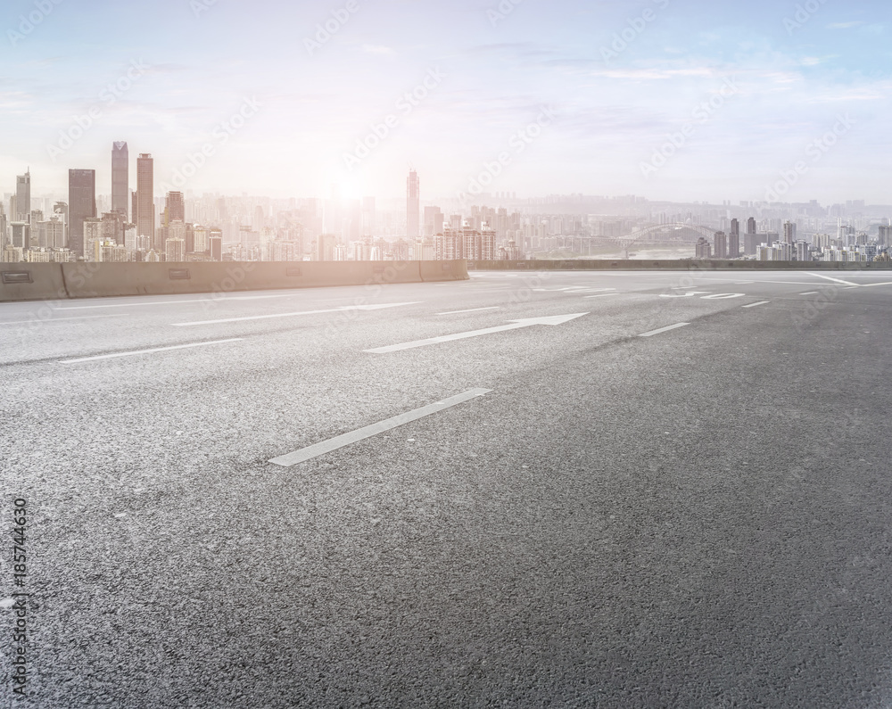 Road pavement and city skyline