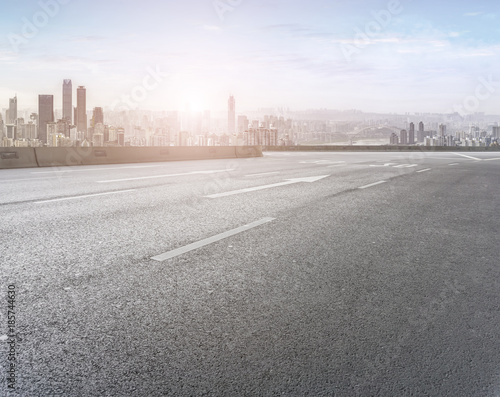 Road pavement and city skyline