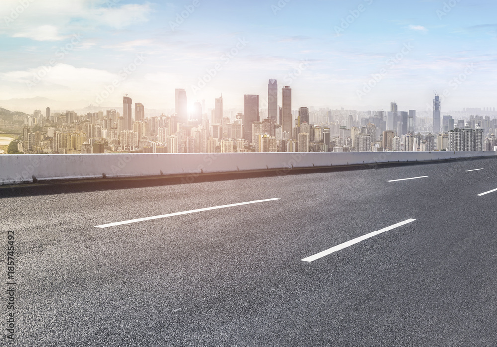 Road pavement and city skyline