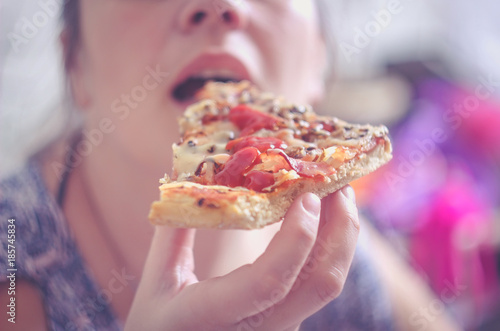 Woman eating pizza