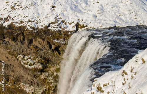 Skógafoss Waterfall, Iceland, with snow in Winter and rainbow photo