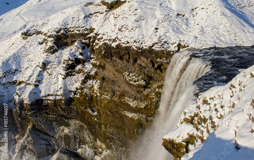 Skógafoss Waterfall, Iceland, with snow in Winter and rainbow