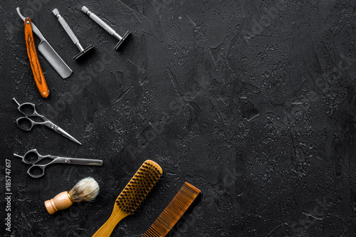 Vintage barbershop tools. Razor, sciccors, brush on black background top view copyspace