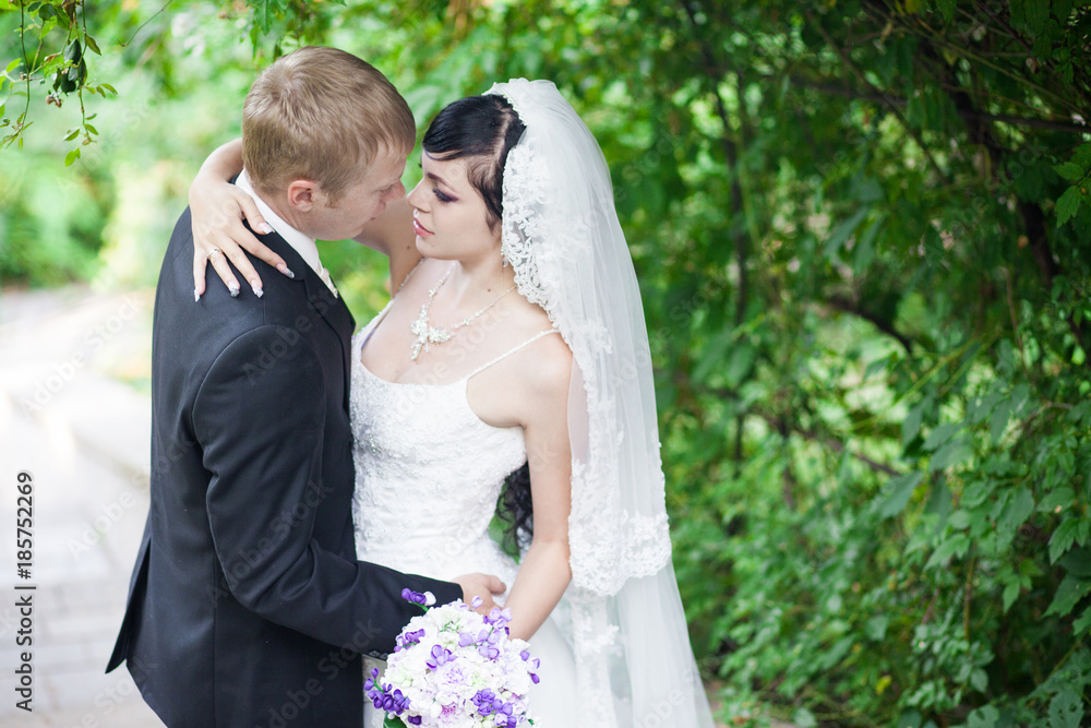 Happy couple. The bride and groom in the park. Wedding sunny day Happy couple. The bride and groom in the park. Wedding sunny day