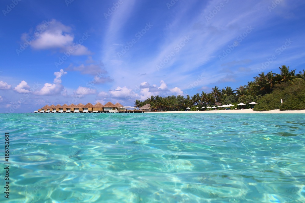View of the beach from the water. Maldivian landscape. Sunny beach and azure water