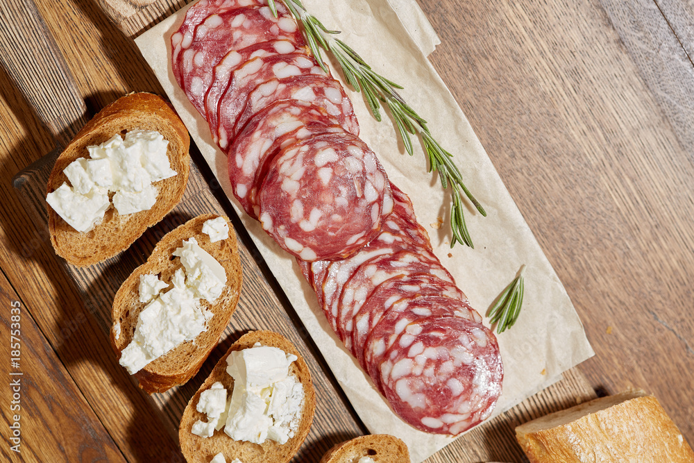 Cheese, vegetables, fruits and spices. Bread, olives and crackers. Mediterranean diet and cuisine. Dark background. Top view. Cheese, vegetables, fruits and spices. Bread, olives and crackers. Mediterranean diet and cuisine. Dark background. Top view.