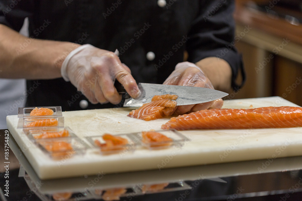 cutting salted salmon in a restaurant cutting salted salmon in a restaurant