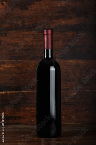 closed bottle of wine on a wooden background