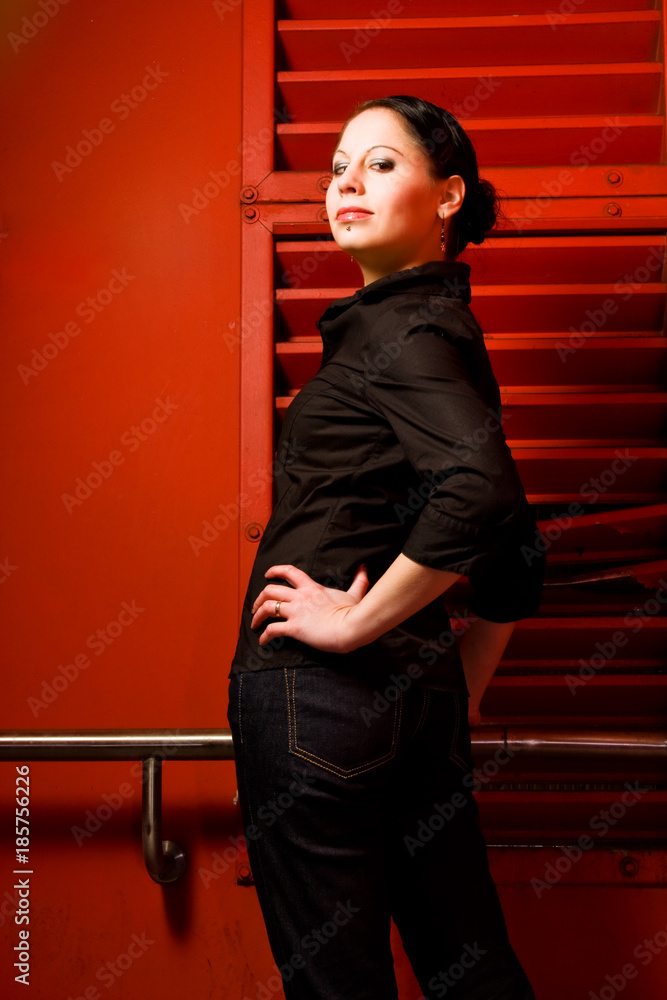 Fototapeta premium Young Woman In Front Of A Red Wall