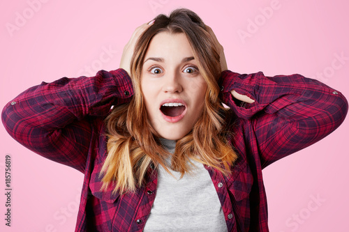 Photo Of Amazed Excited Female Opens Mouth And Keeps Hands On Head Screams In Excitement Doesn T Expect To Hear Some News Poses Against Pink Studio Background Excitement And Amazement Concept Stock Photo Photo Of Amazed Excited Female Opens Mouth And Keeps Hands On Head Screams In Excitement Doesn T Expect To Hear Some News Poses Against Pink Studio Background Excitement And Amazement Concept Stock Photo