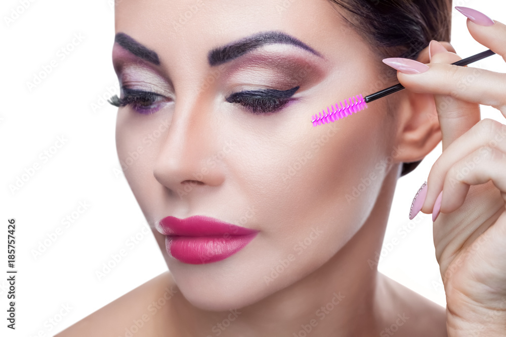 Portrait of a beautiful woman with long eyelashes and beautiful make-up in a beauty salon. The procedure for eyelash extension is close-up.