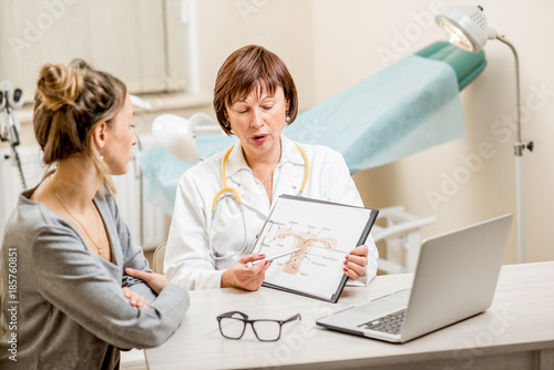 Young woman patient with a senior gynecologist during the consultation in the office photo