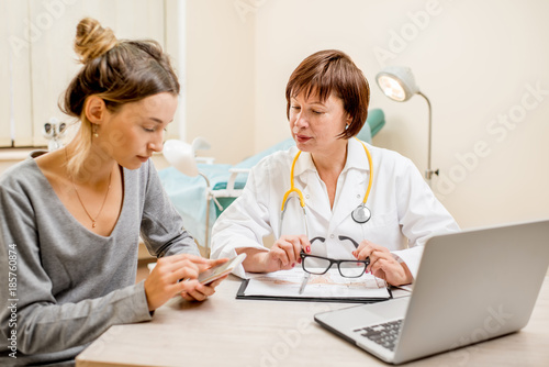 Young woman patient with a senior gynecologist during the consultation in the office