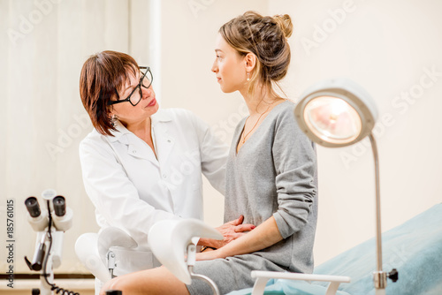 Young woman patient with a senior gynecologist during the consultation in the gynecological office photo